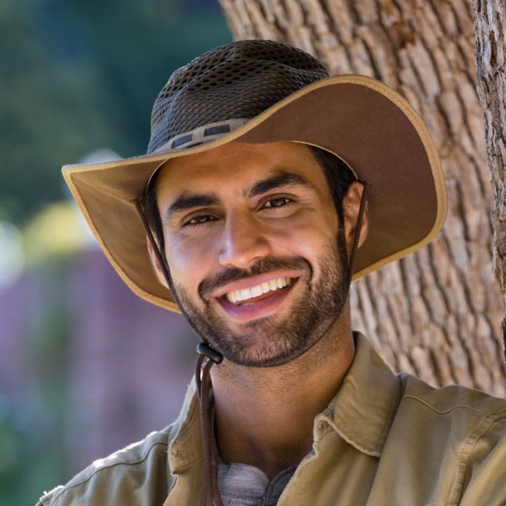 smiling man standing with arms crossed near tree t d8p8b96 1 1 1.jpg